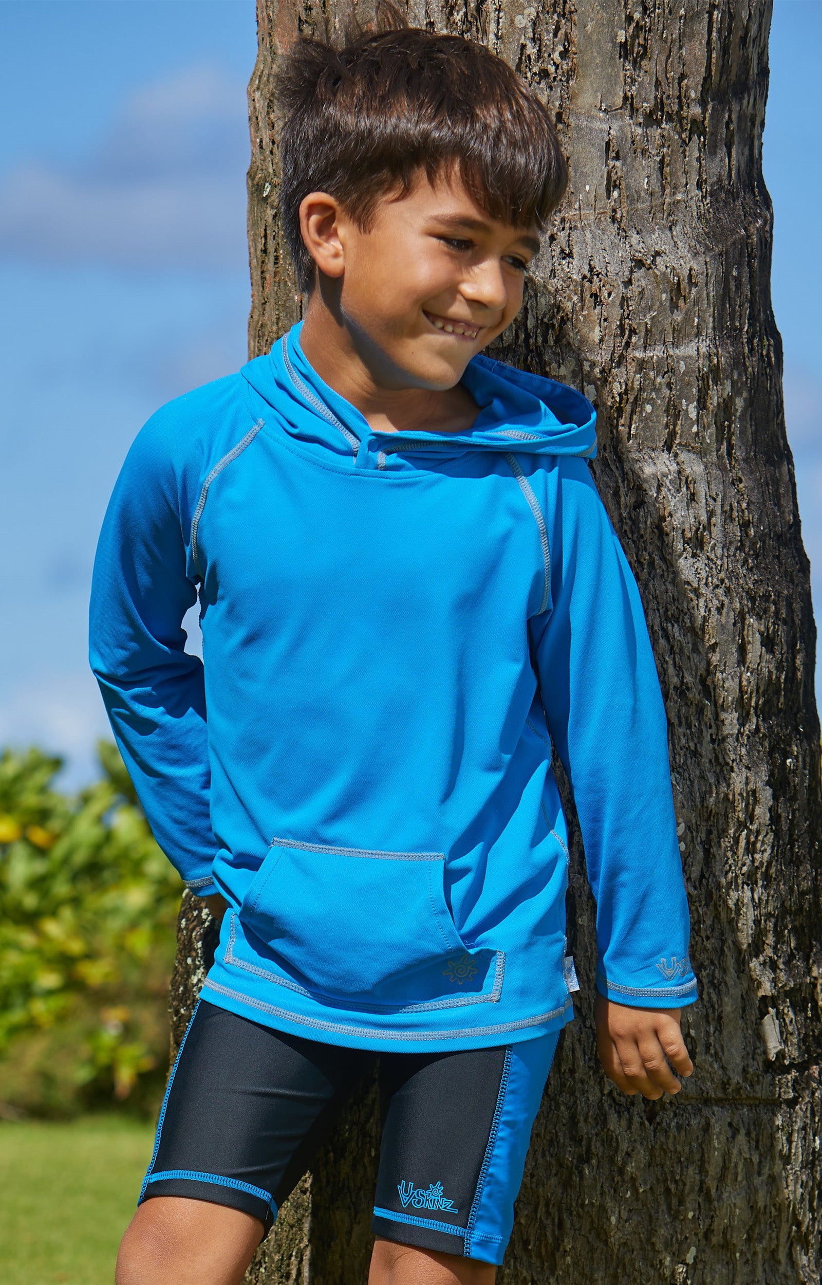 Young boy in UV Skinz's boy's pullover hoodie in royal|royal
