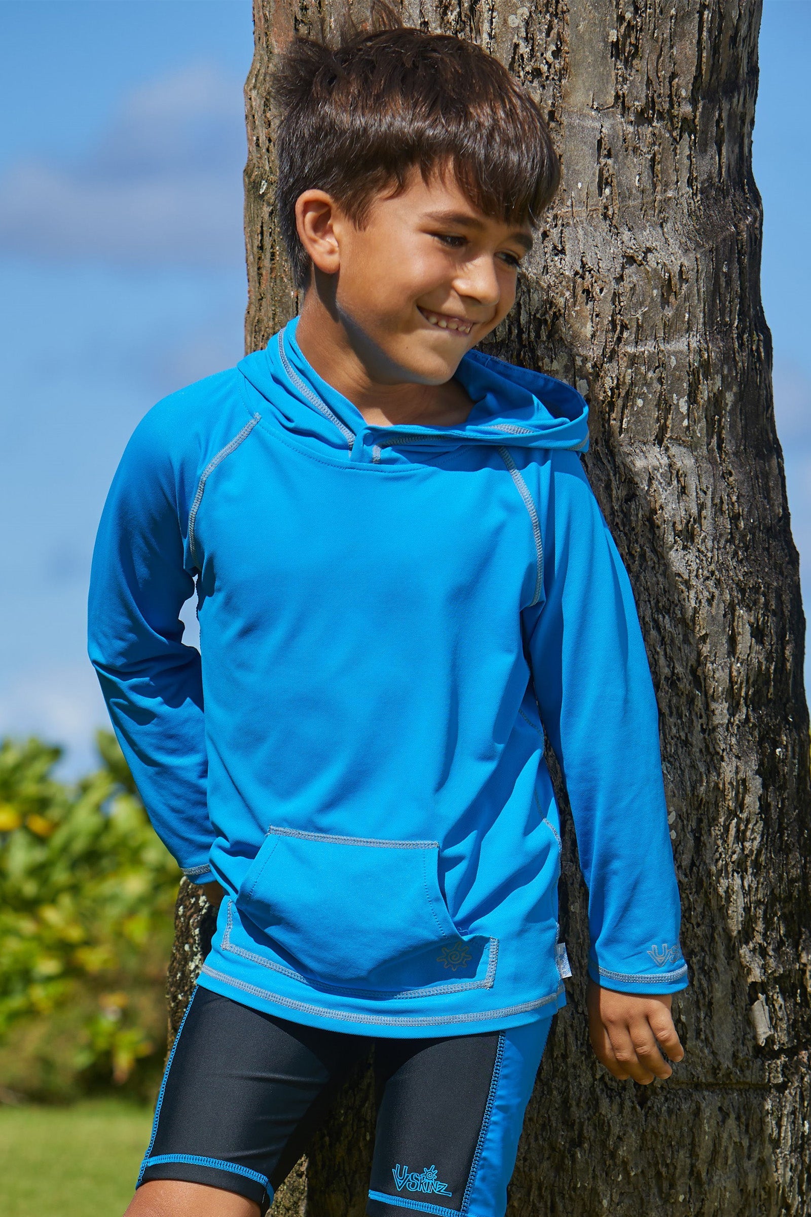 Young boy in UV Skinz's boy's pullover hoodie in royal|royal