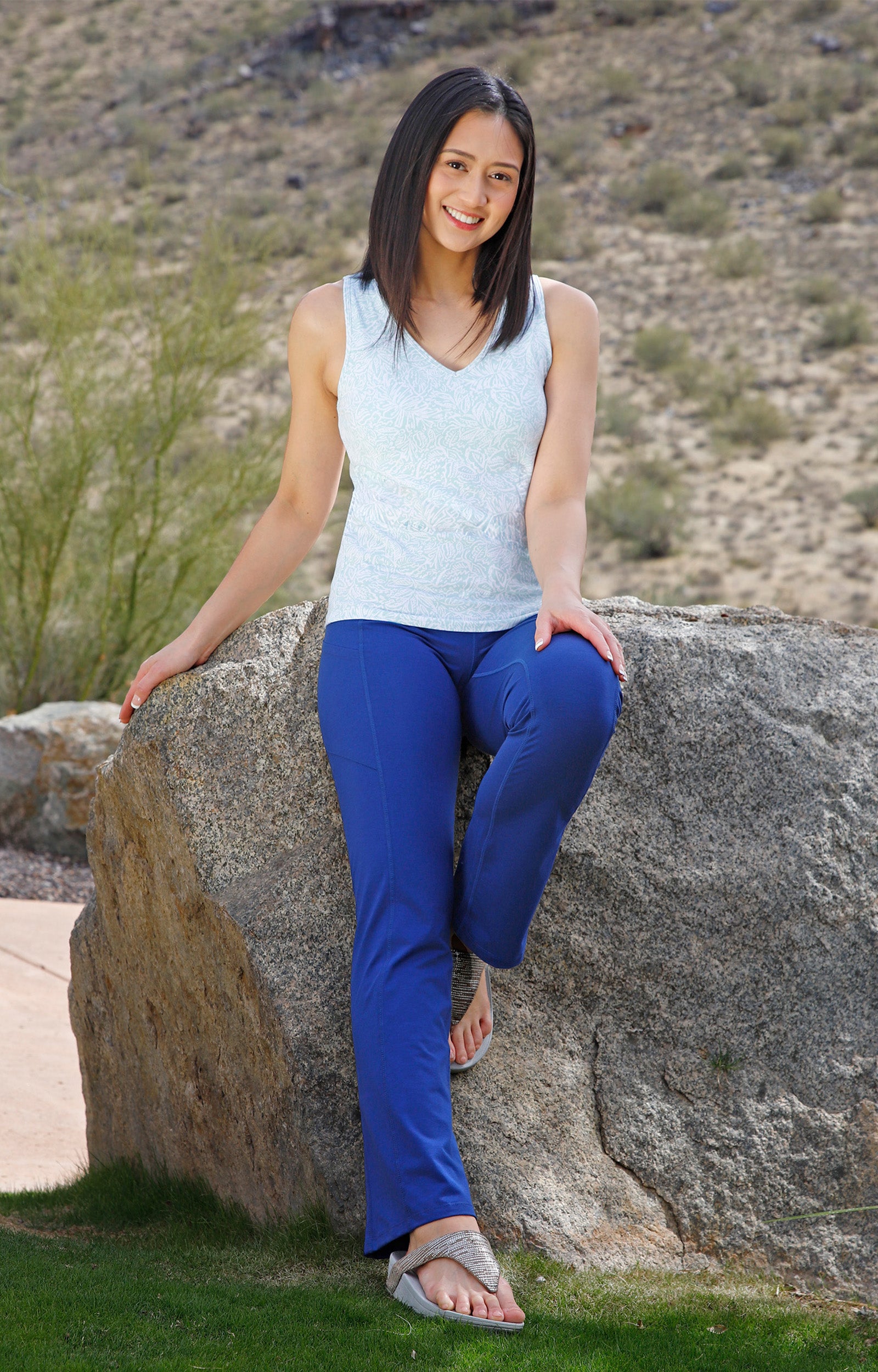 woman sitting on rock wearing womens everyday shelf bra tank in imprint leaves|imprint-leaves