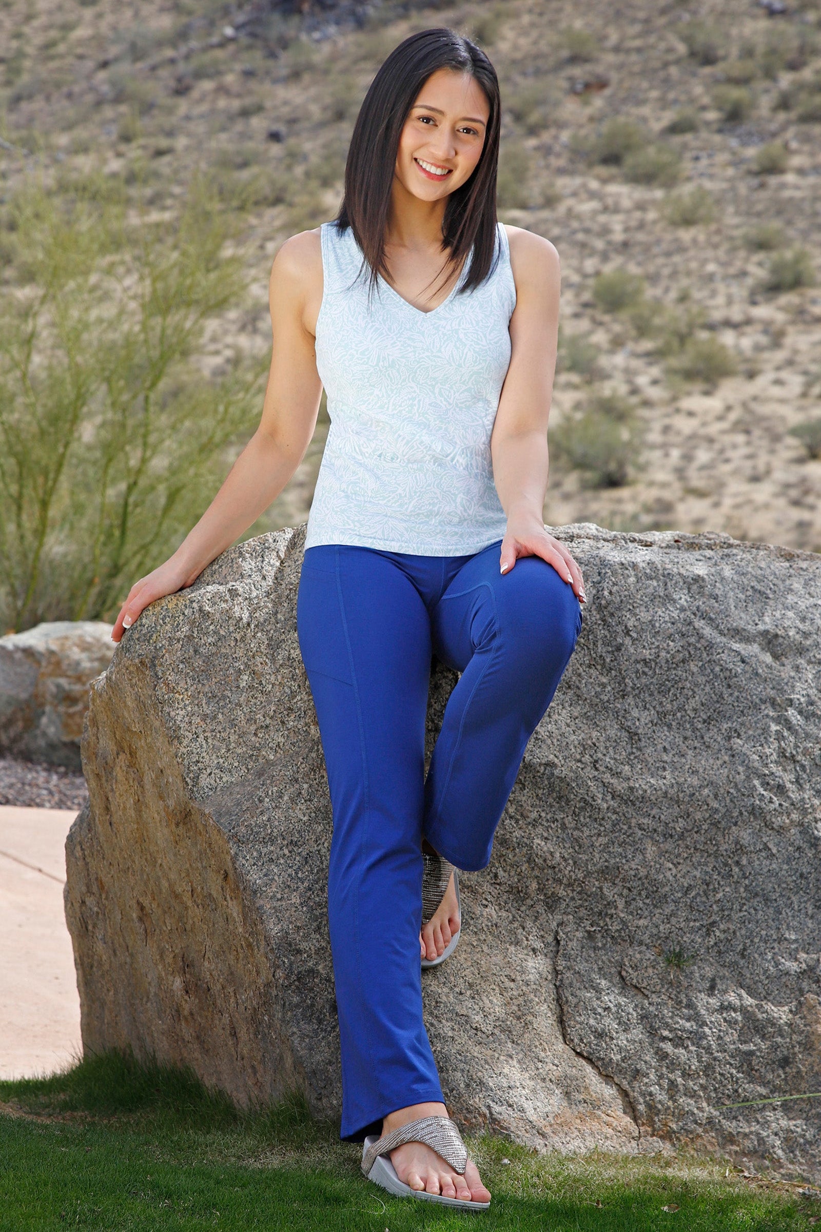 woman sitting on rock wearing womens everyday shelf bra tank in imprint leaves|imprint-leaves