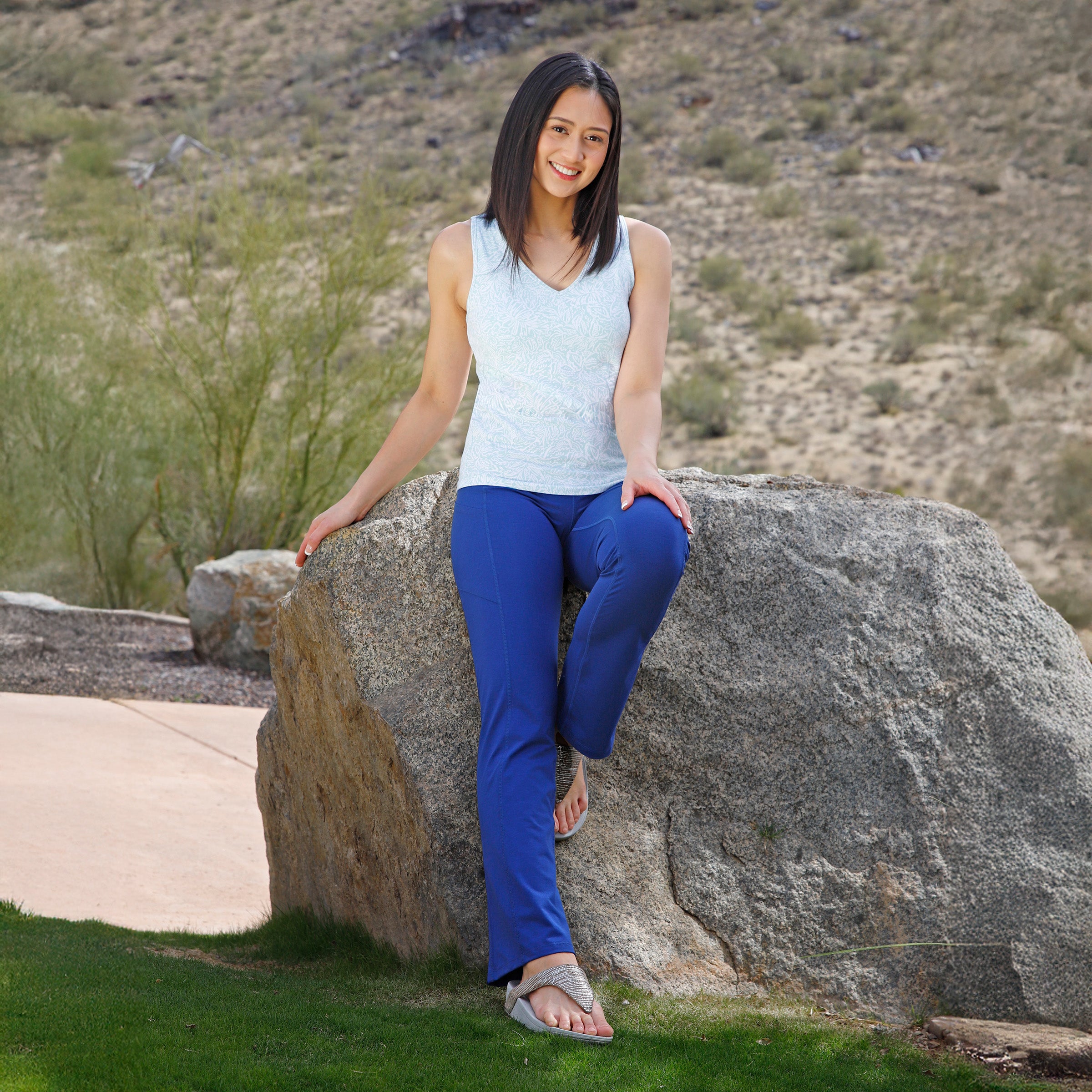 woman sitting on rock wearing womens everyday shelf bra tank in imprint leaves|imprint-leaves