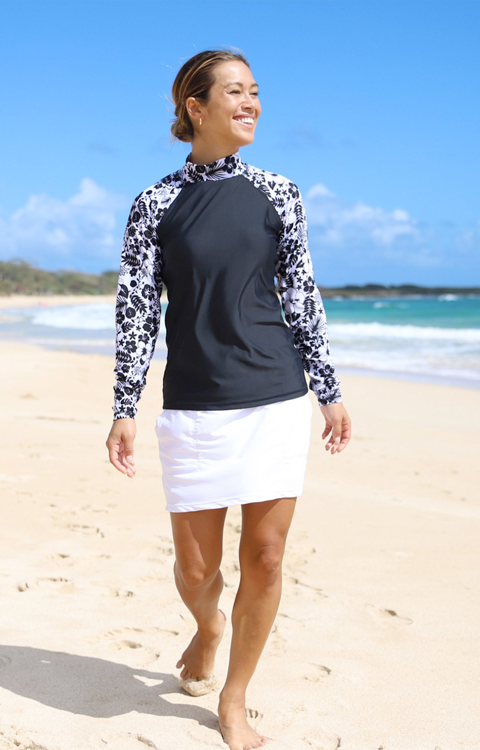 Woman enjoying the sun in women's active swim skirt in white|white