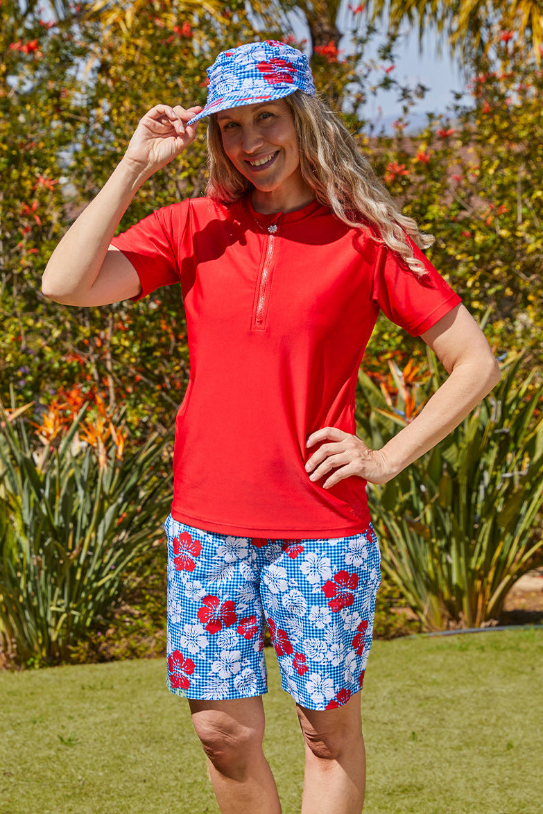Woman wearing UV Skinz's women's board shorts in red americana gingham|red-americana-gingham