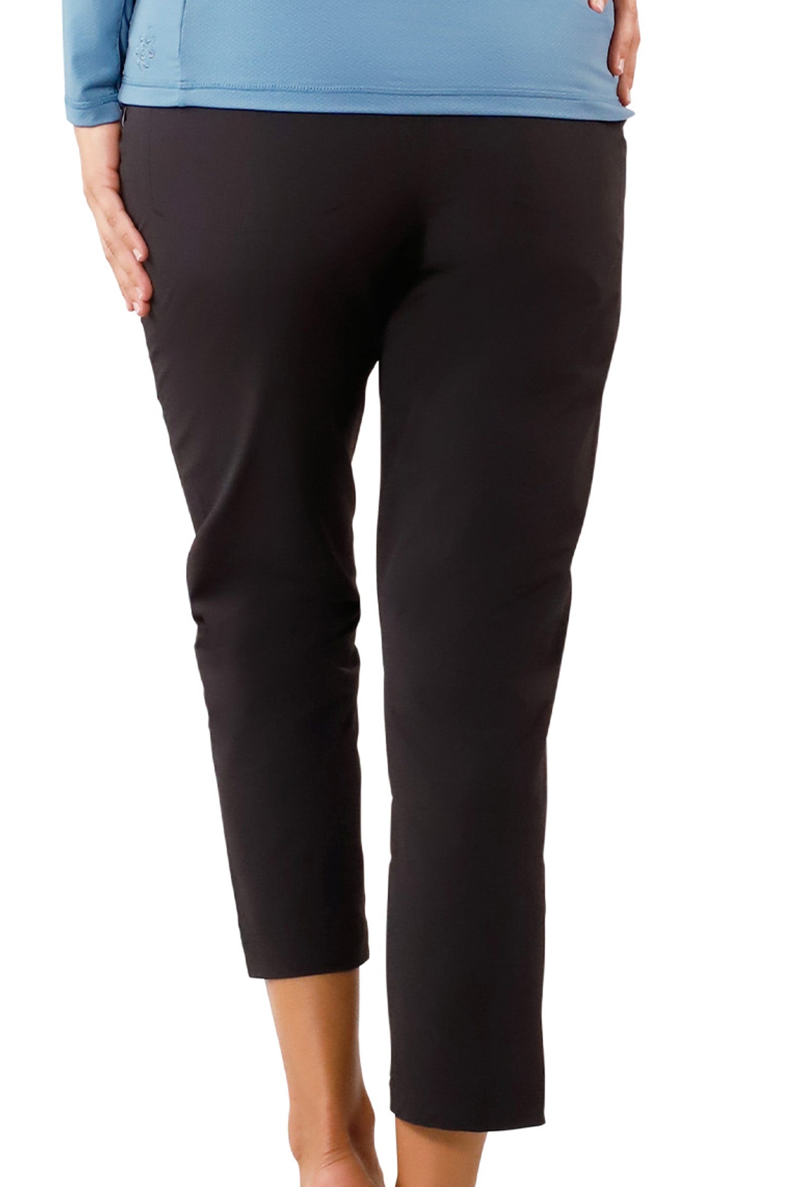back view of woman in walking capris in black|black