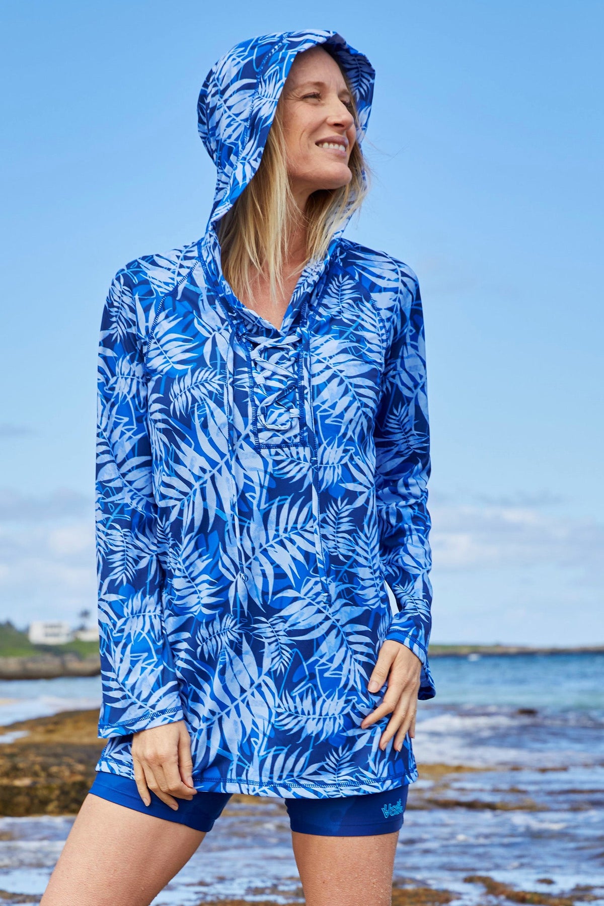 Woman on the Beach in the Women's Hooded Beach Cover Up in Navy Blue Palms|navy-blue-palms