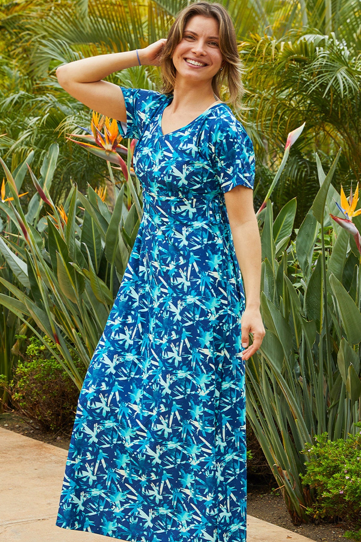 woman in UV Skinz's women's maxi dress in tie dye burst|tie-dye-burst