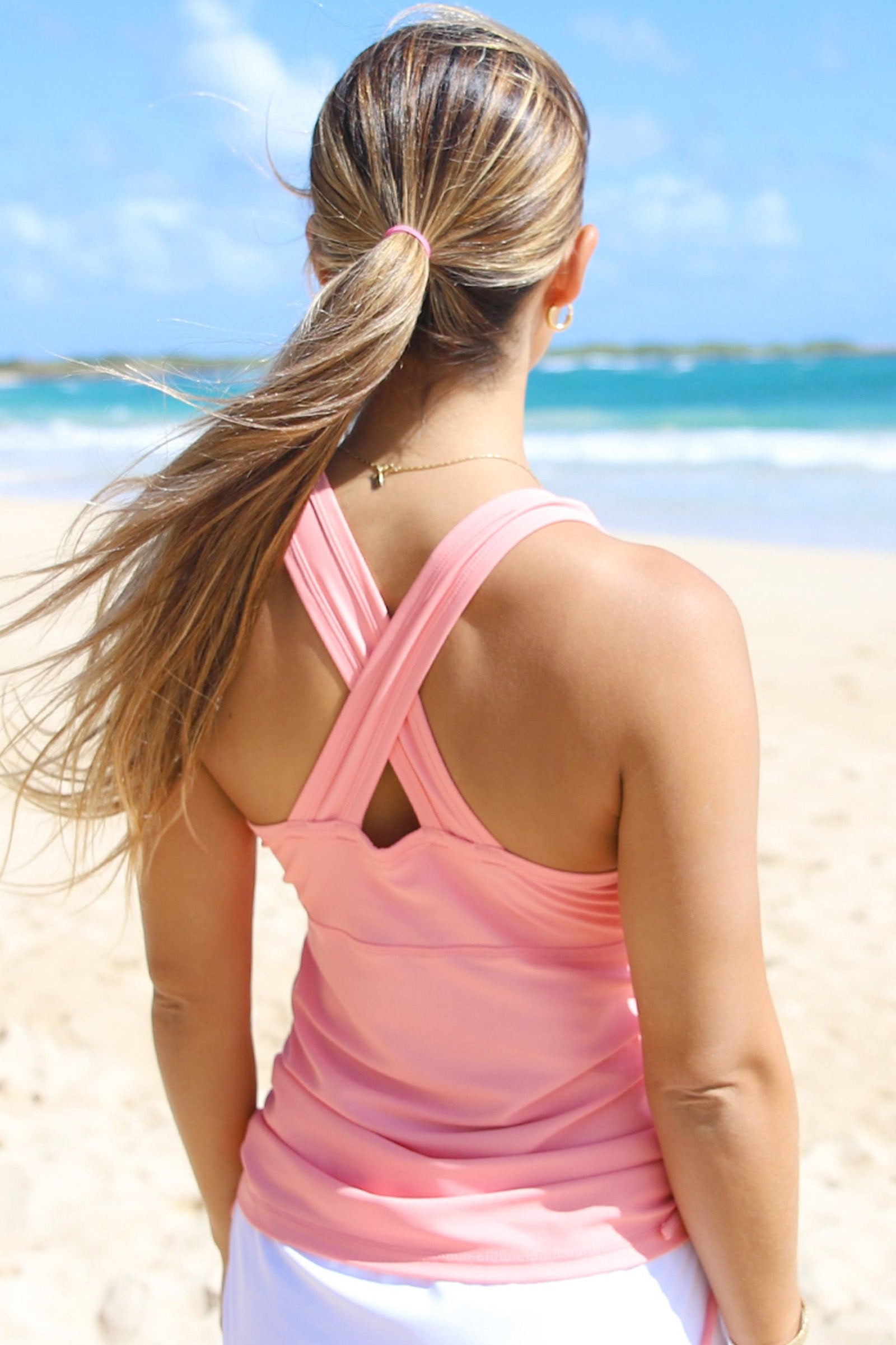 Woman on the beach in UV Skinz's women's ruched swim tank top|flamingo