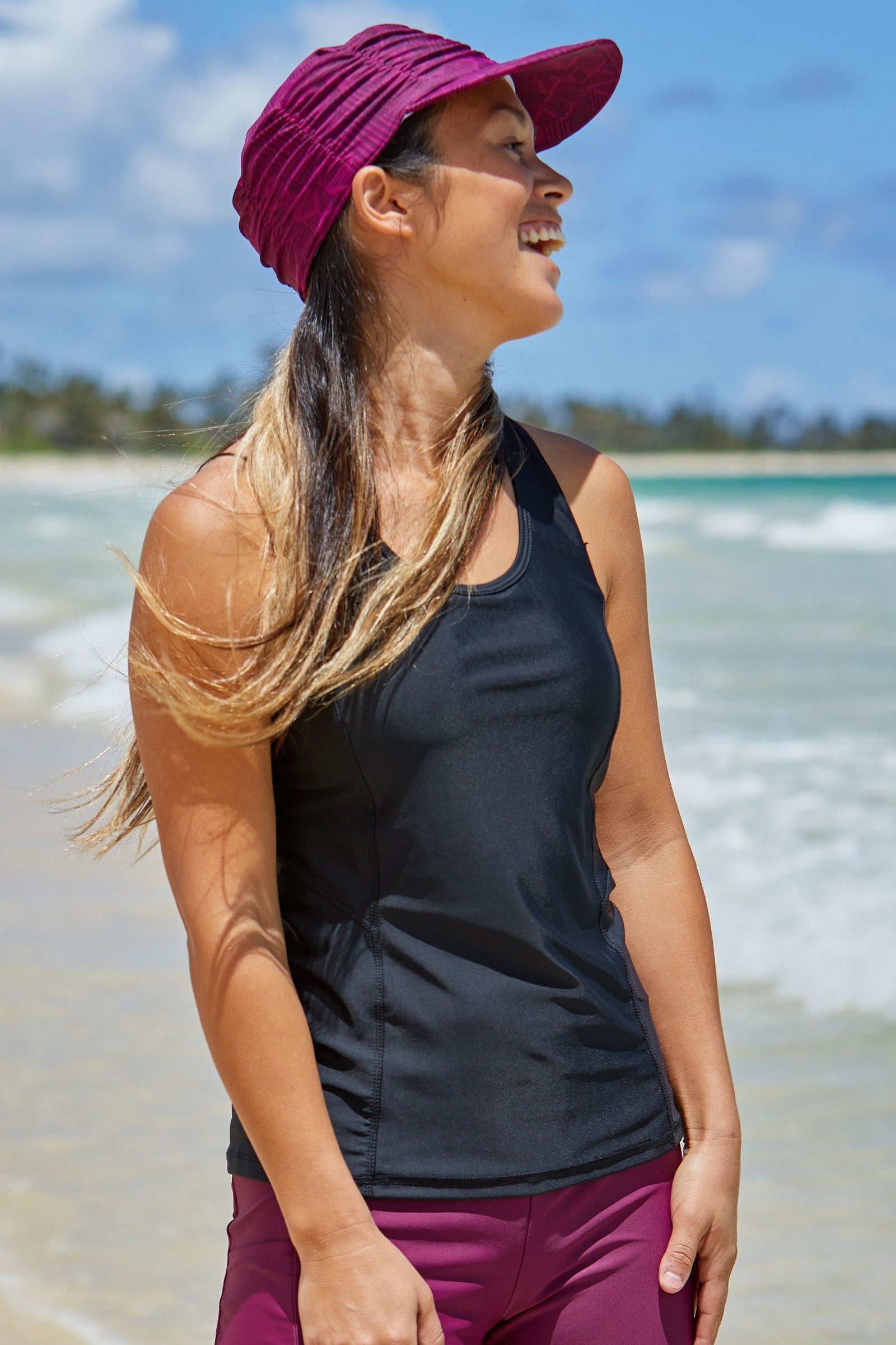 Woman in UV Skinz's women's swim tank top and matching swim hat|wild-rose