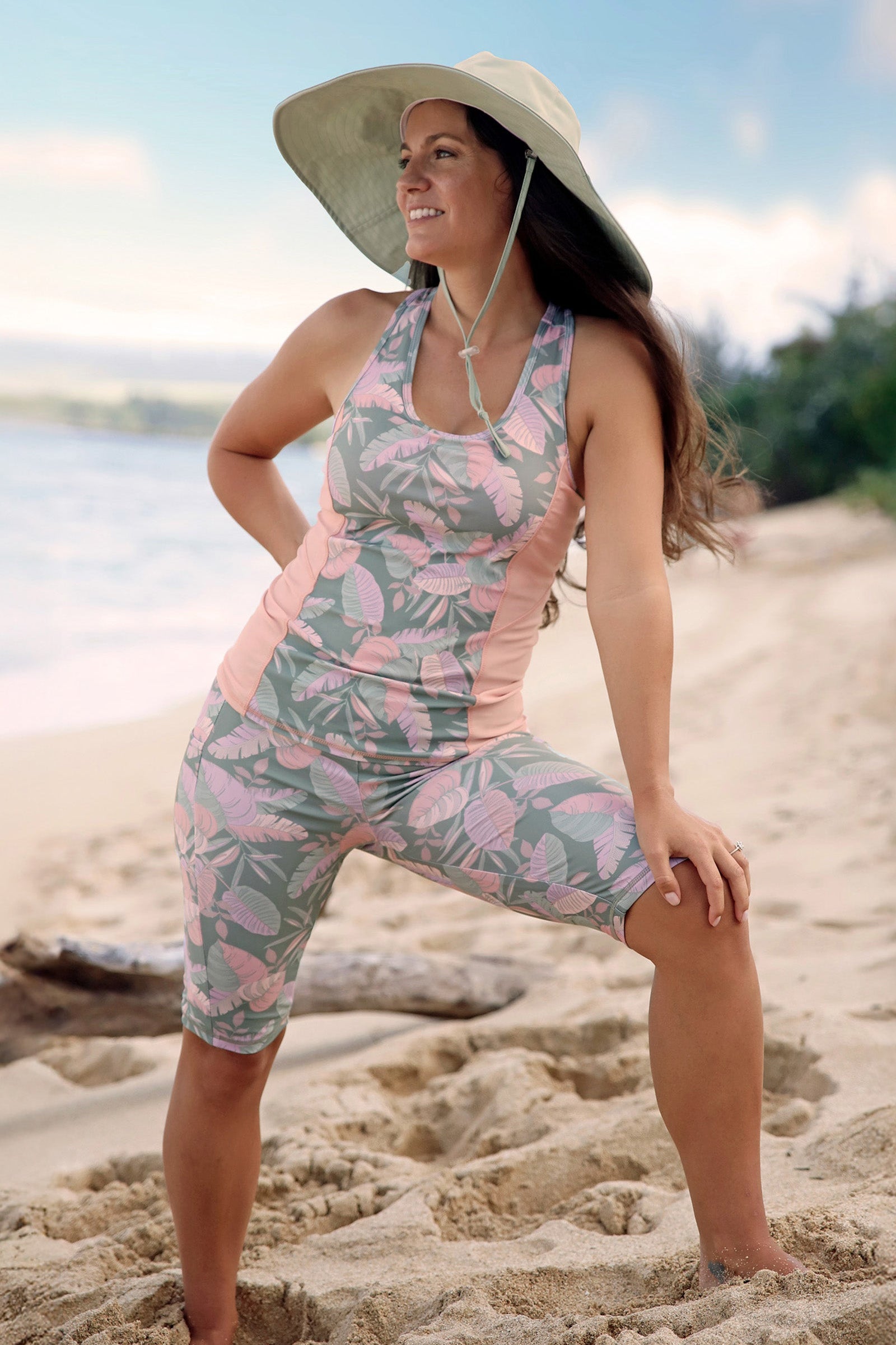 woman posing on the beach in racerback swim tank in lily pad leavescape|lily-pad-leavescape