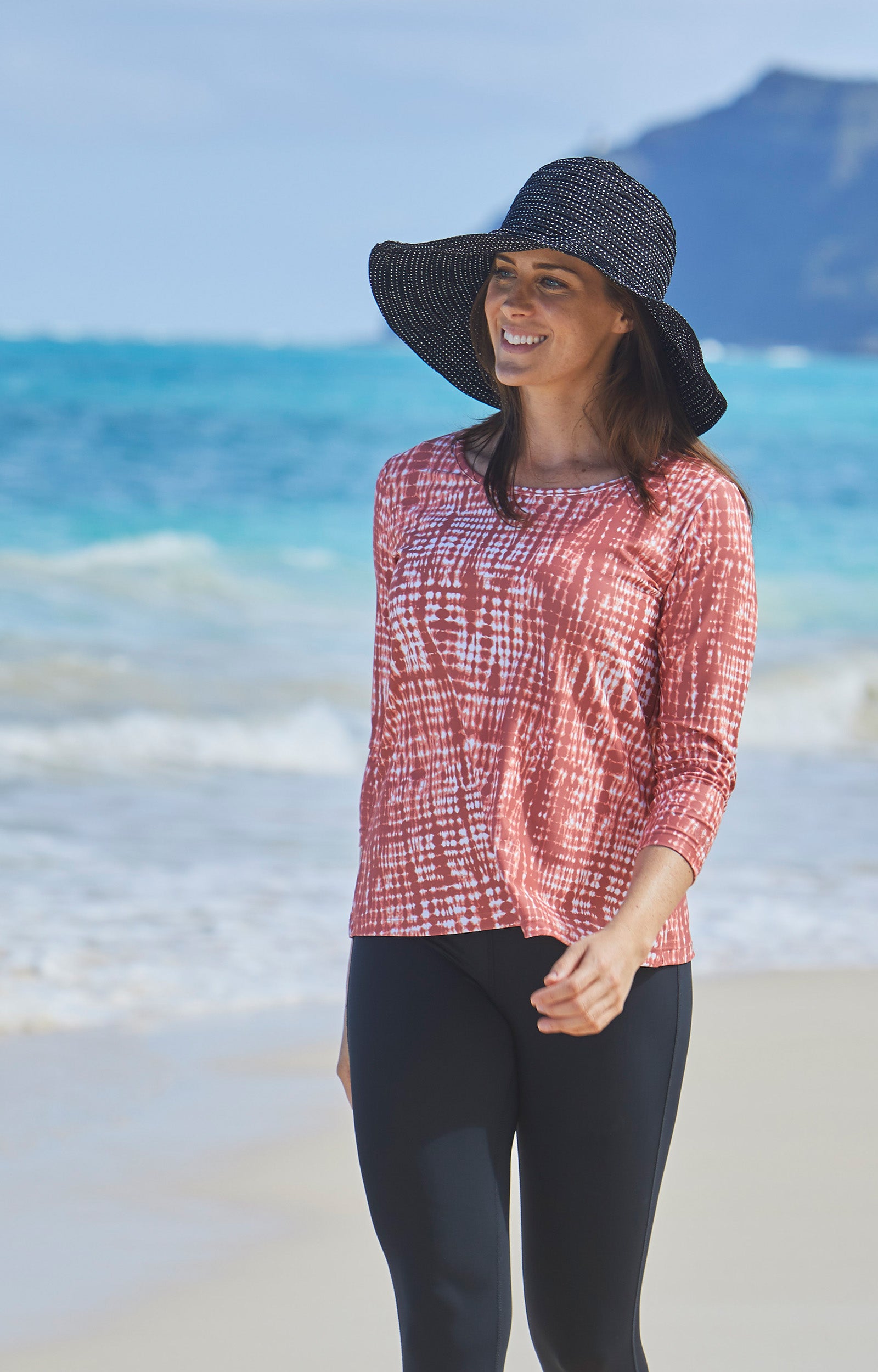 Woman in UV Skinz's women's wide brim dot hat in black|black