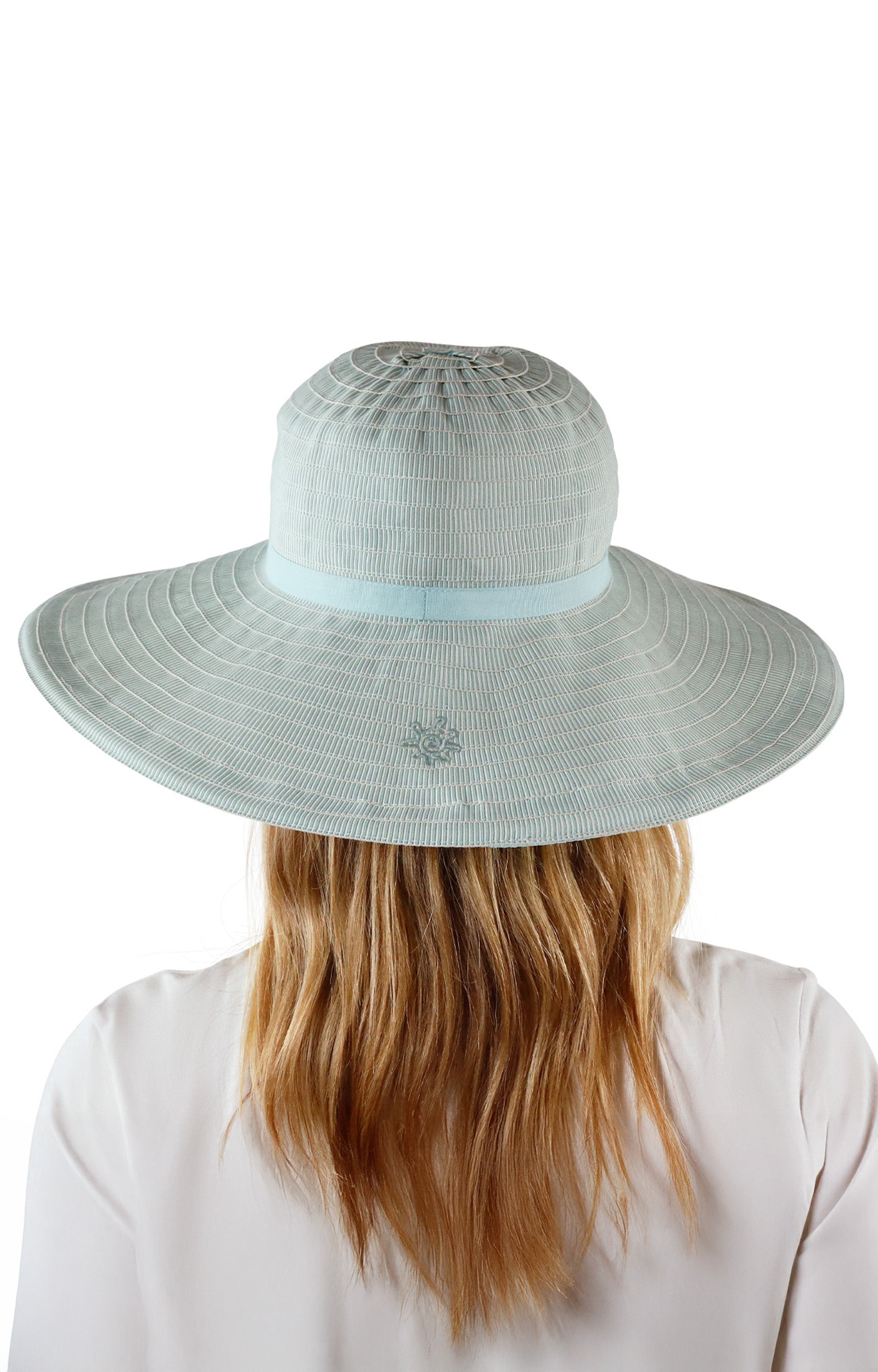 back view of woman in river pacifica hat|river