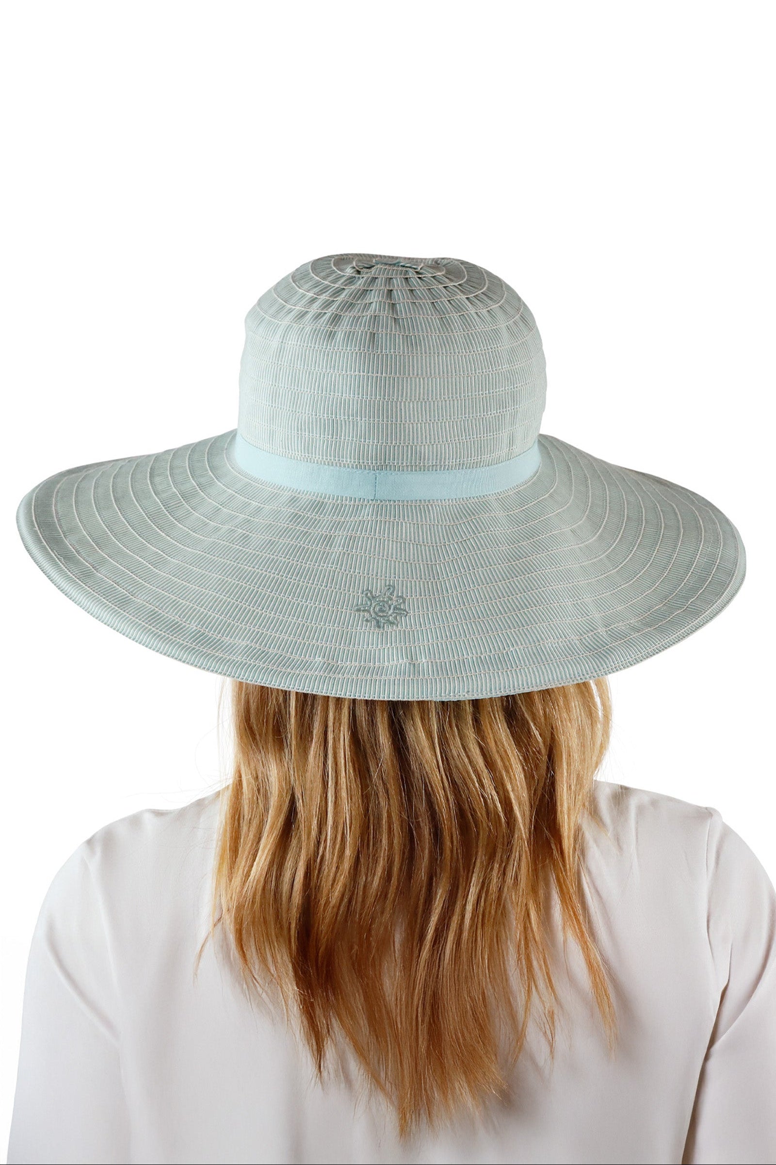 back view of woman in river pacifica hat|river