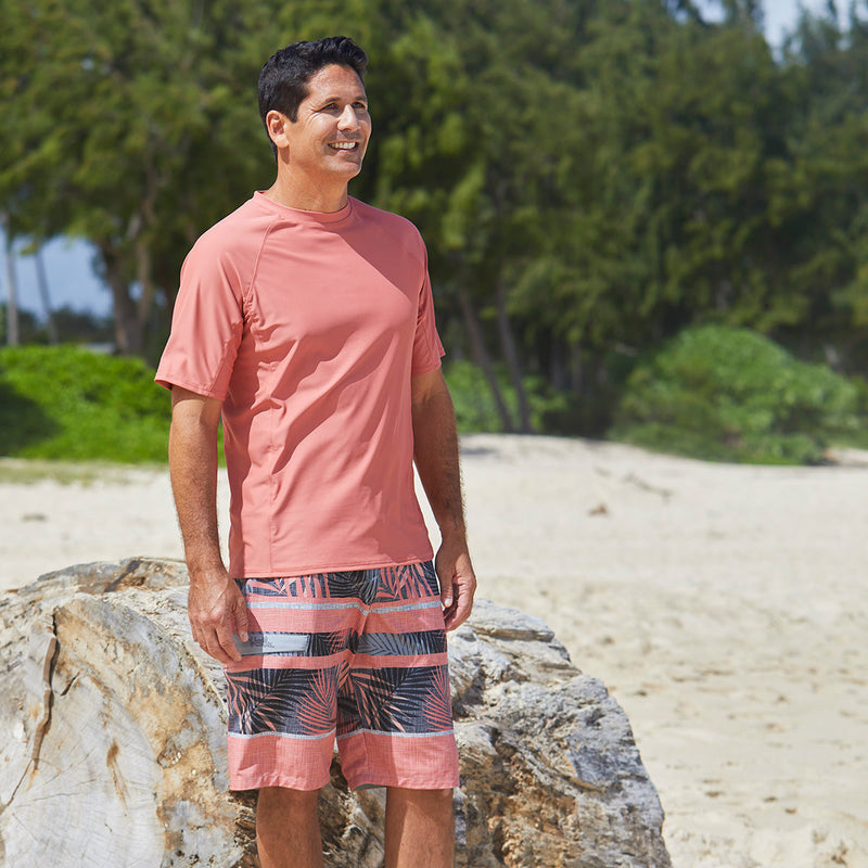 man on the beach in UV Skinz's men's short sleeve swim shirt in canyon|canyon