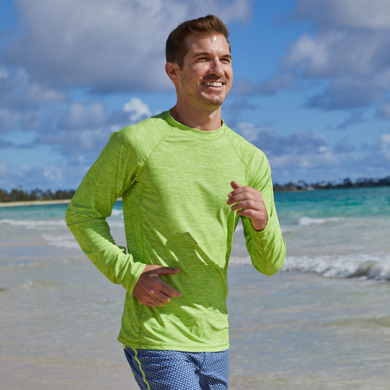 Man running on the beach in UV Skinz's men's long sleeve crew swim shirt in electric green jaspe|electric-green-jaspe