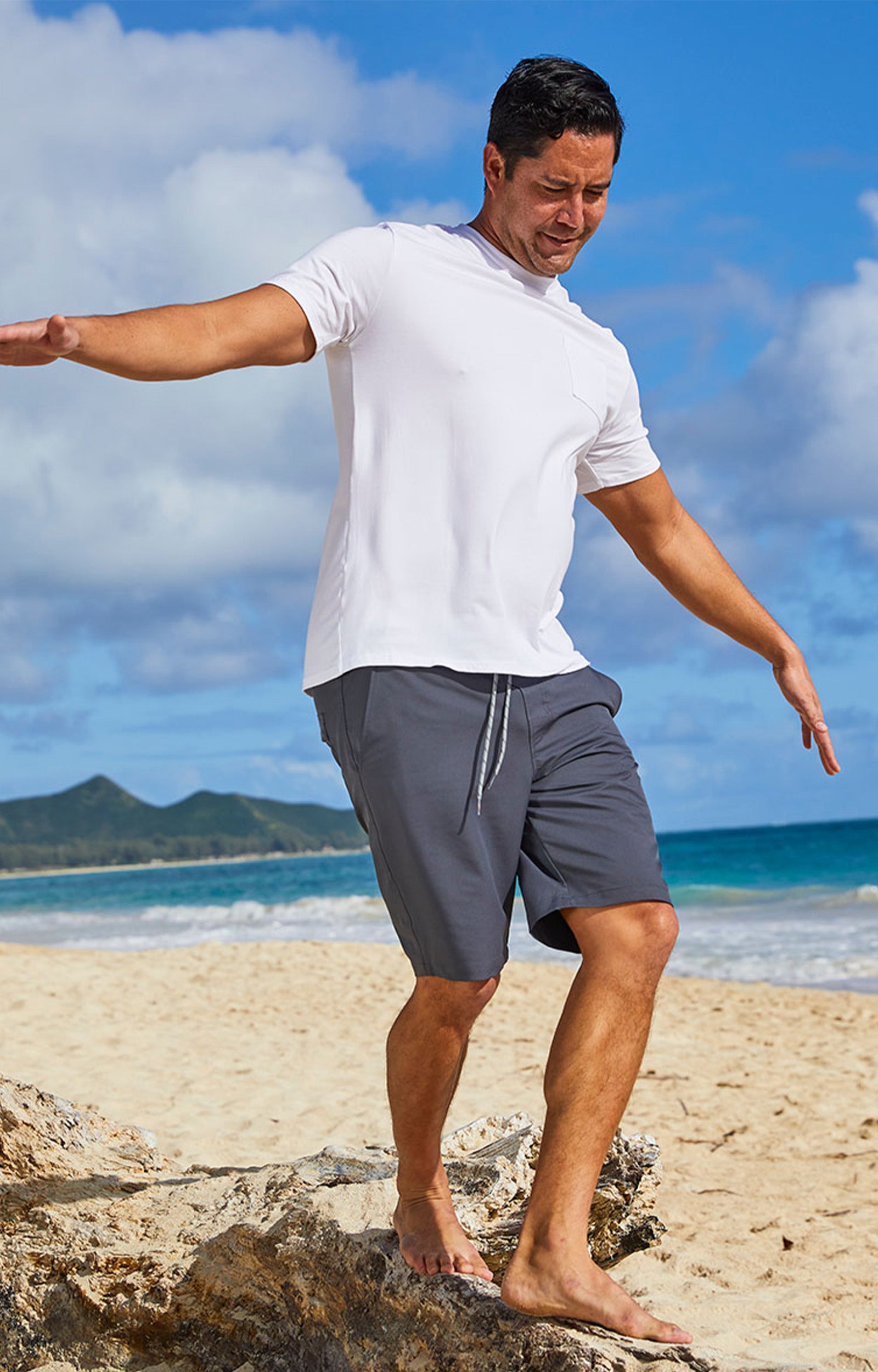 Man wearing UV Skinz's men's classic trunks in charcoal|charcoal