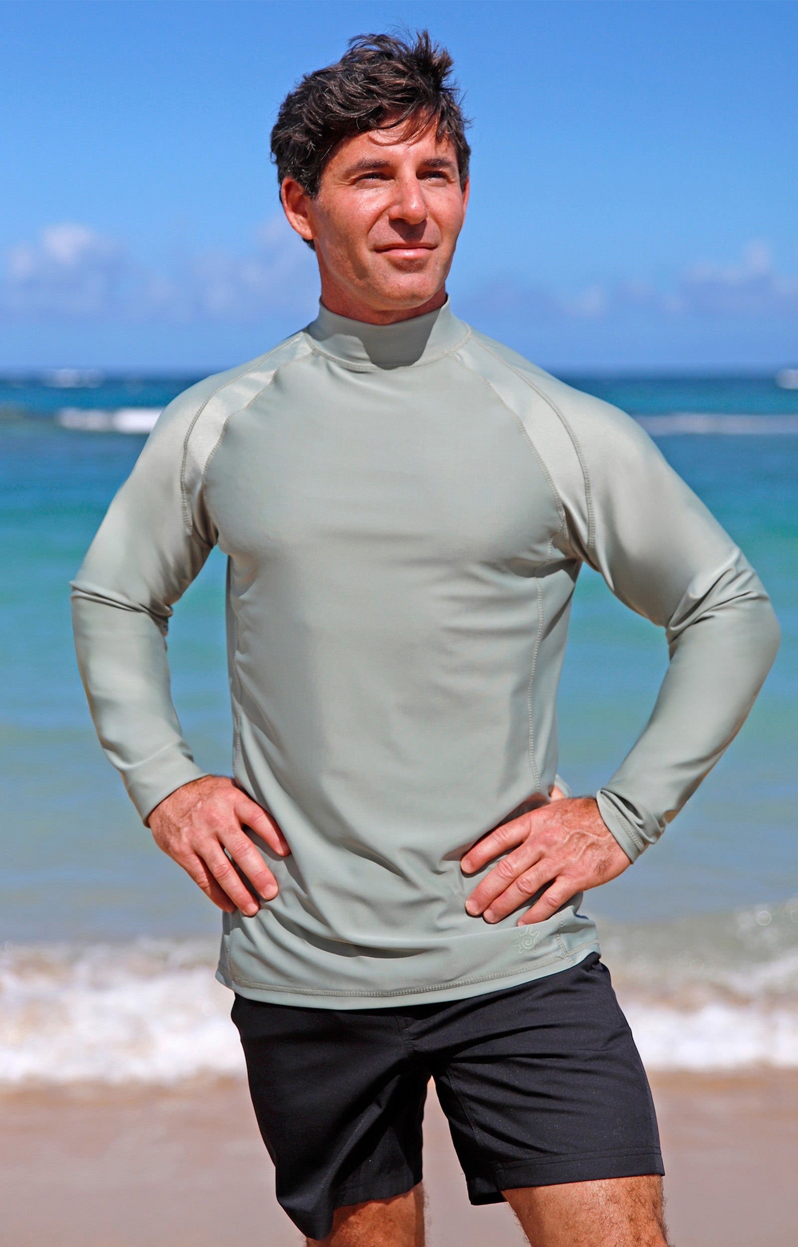 man posing by beach in black adventure shorts|black