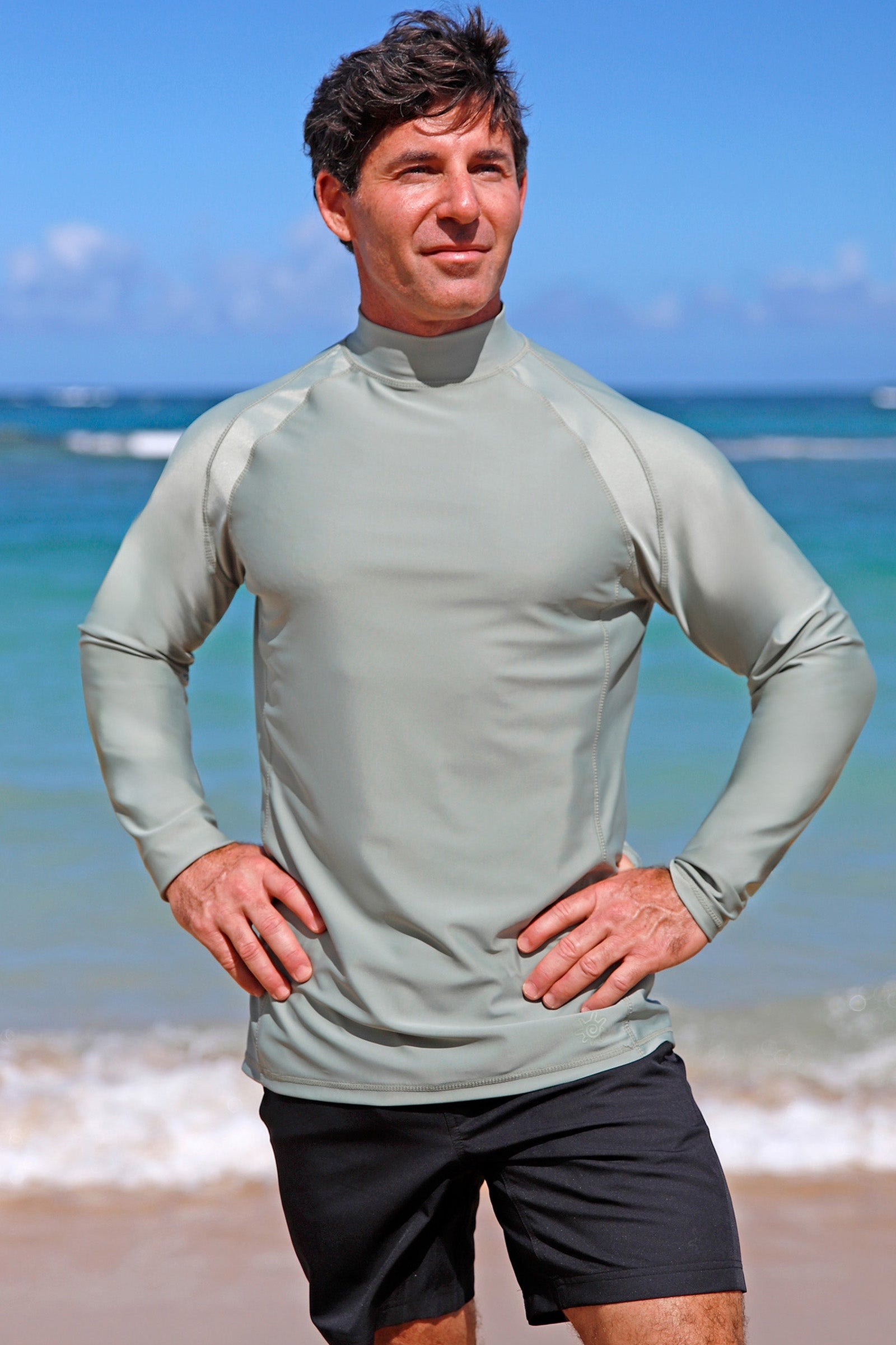 man posing by beach in black adventure shorts|black