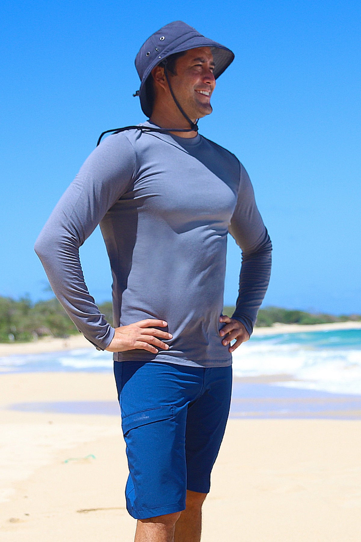 Man on the beach in UV Skinz's board shorts|dark-navy