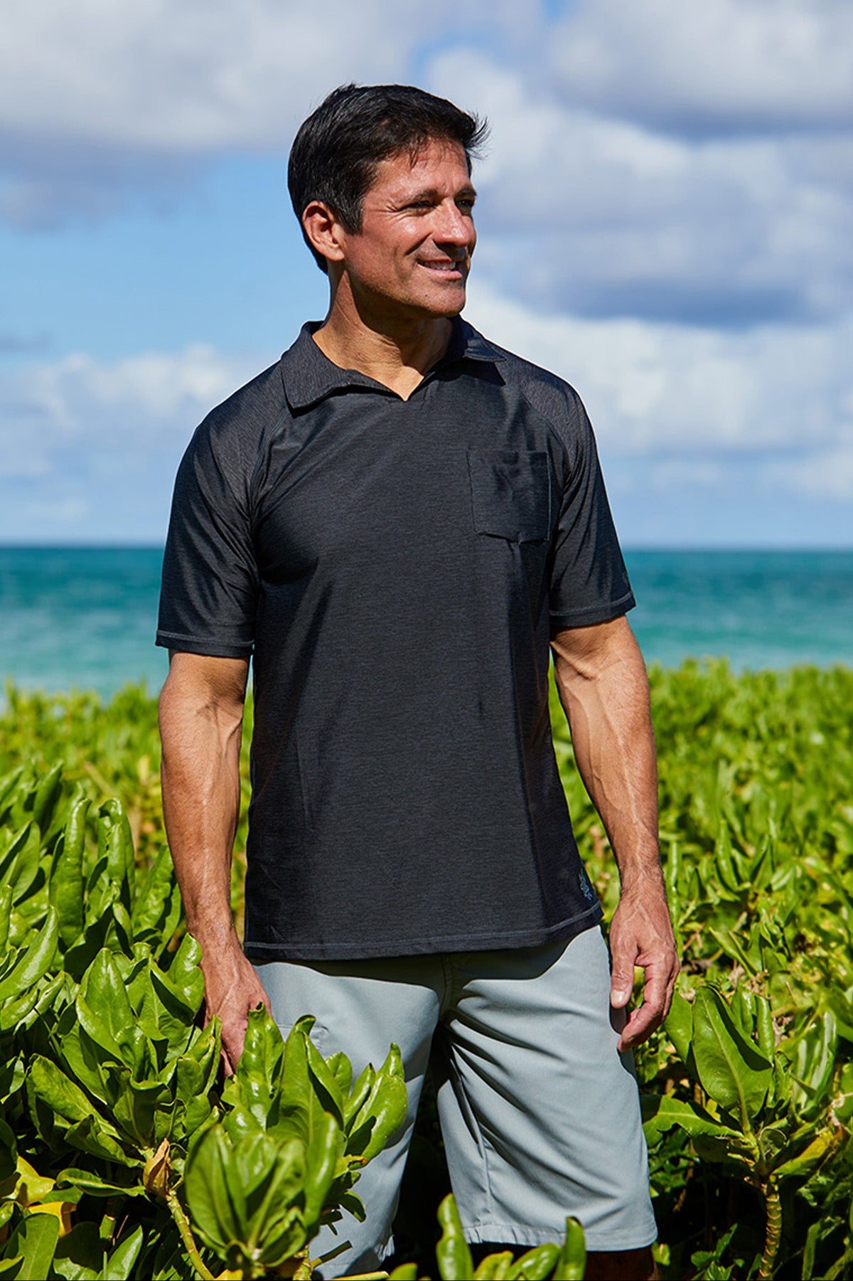 Man wearing UV Skinz's men's coastal board shorts in grey on the beach|grey