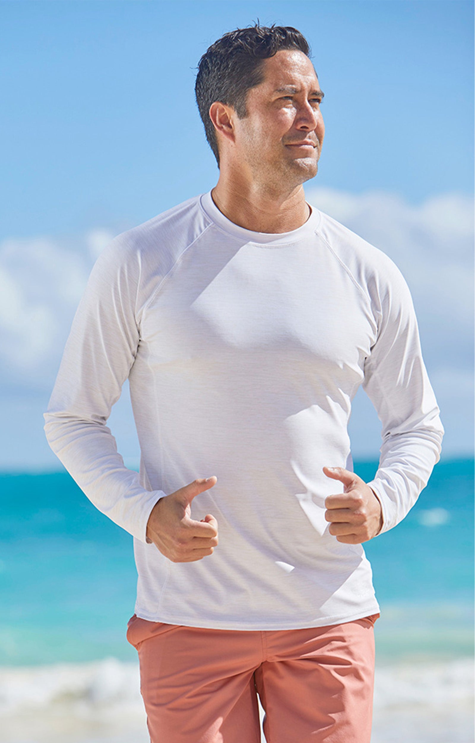 Man on the beach in UV Skinz's men's long sleeve crew swim shirt|belize