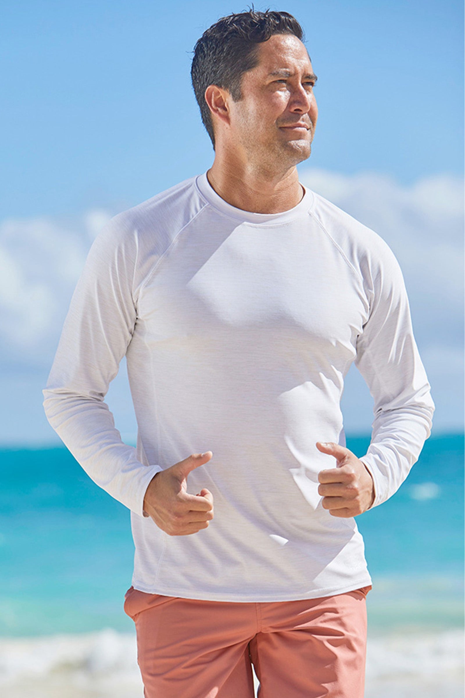 Man on the beach in UV Skinz's men's long sleeve crew swim shirt|belize