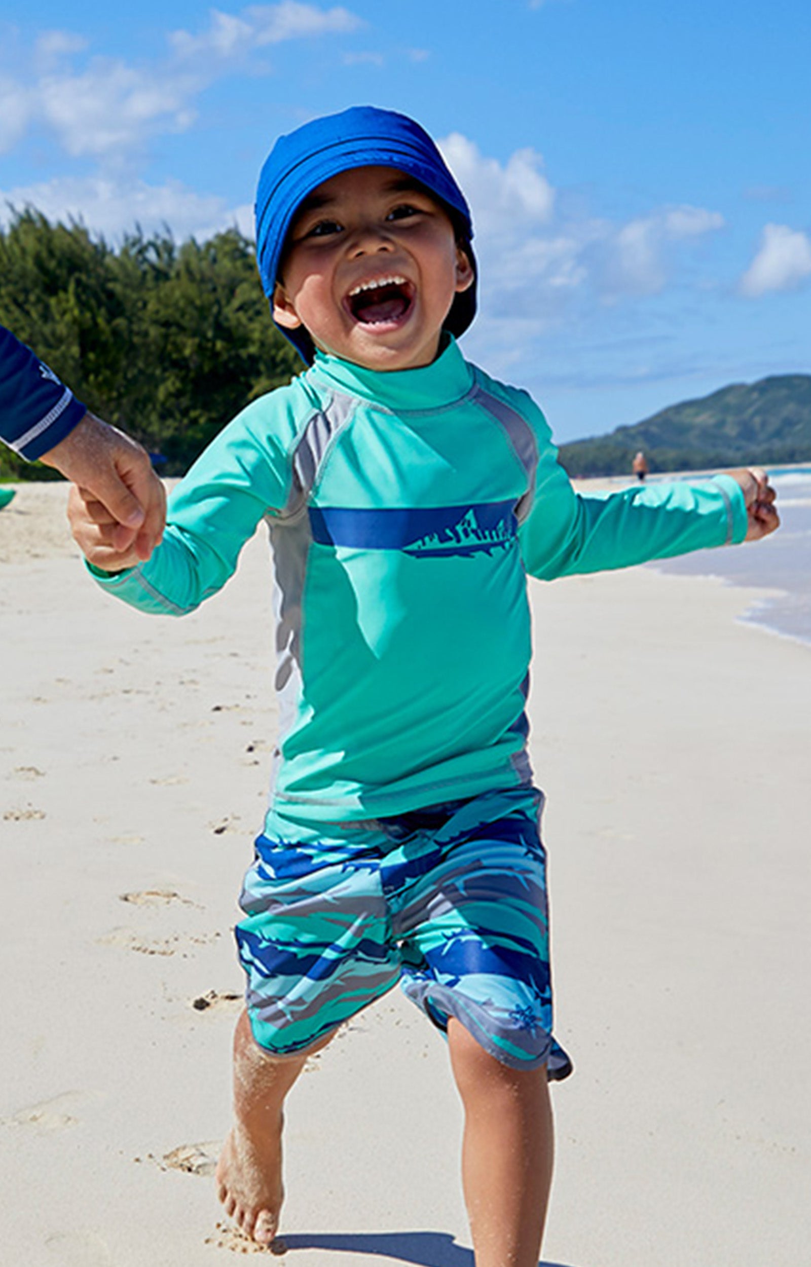 Kids playing in UV Skinz's kid's adjustable flap sun hats|deep-sea
