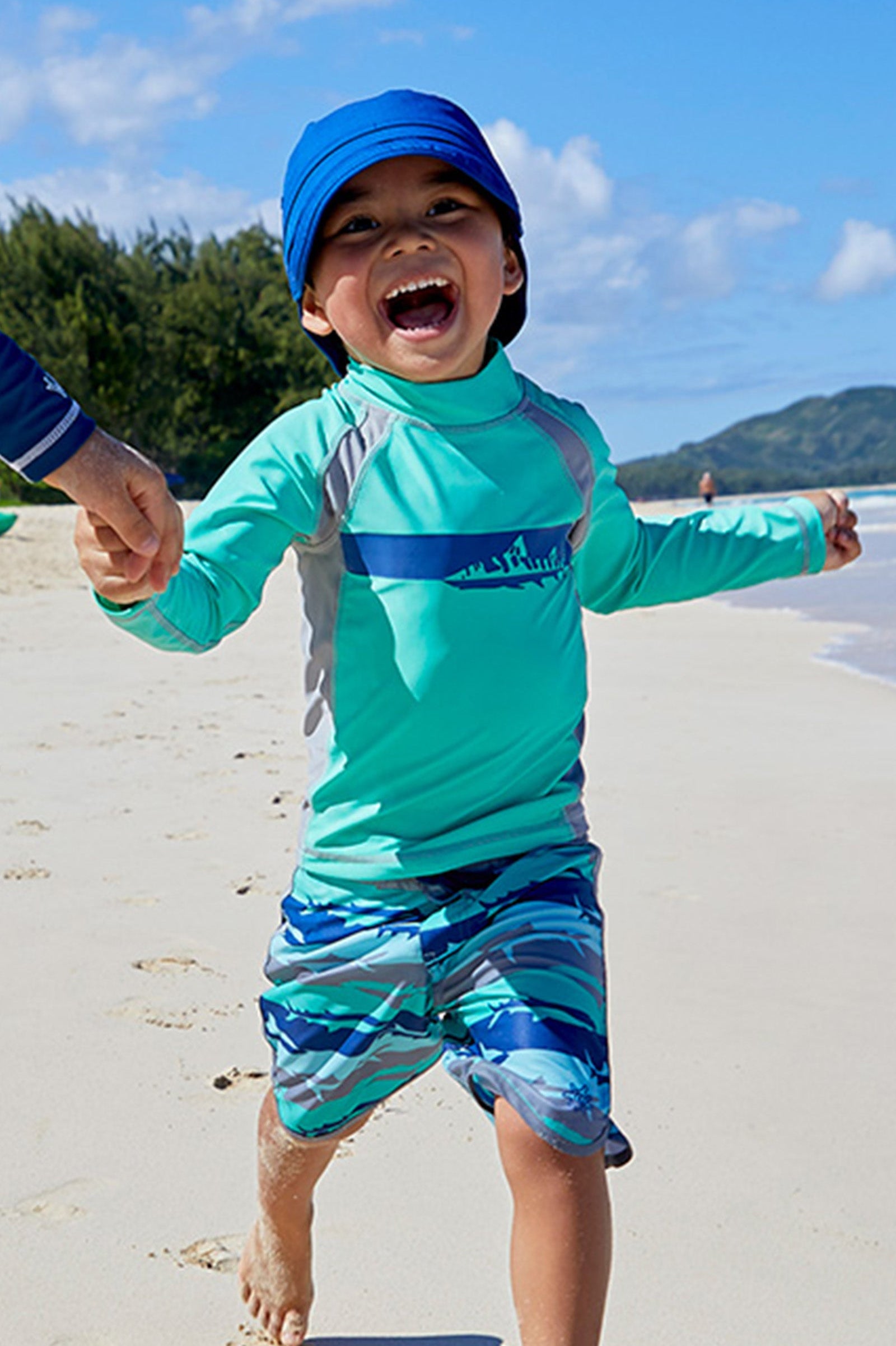 Kids playing in UV Skinz's kid's adjustable flap sun hats|deep-sea