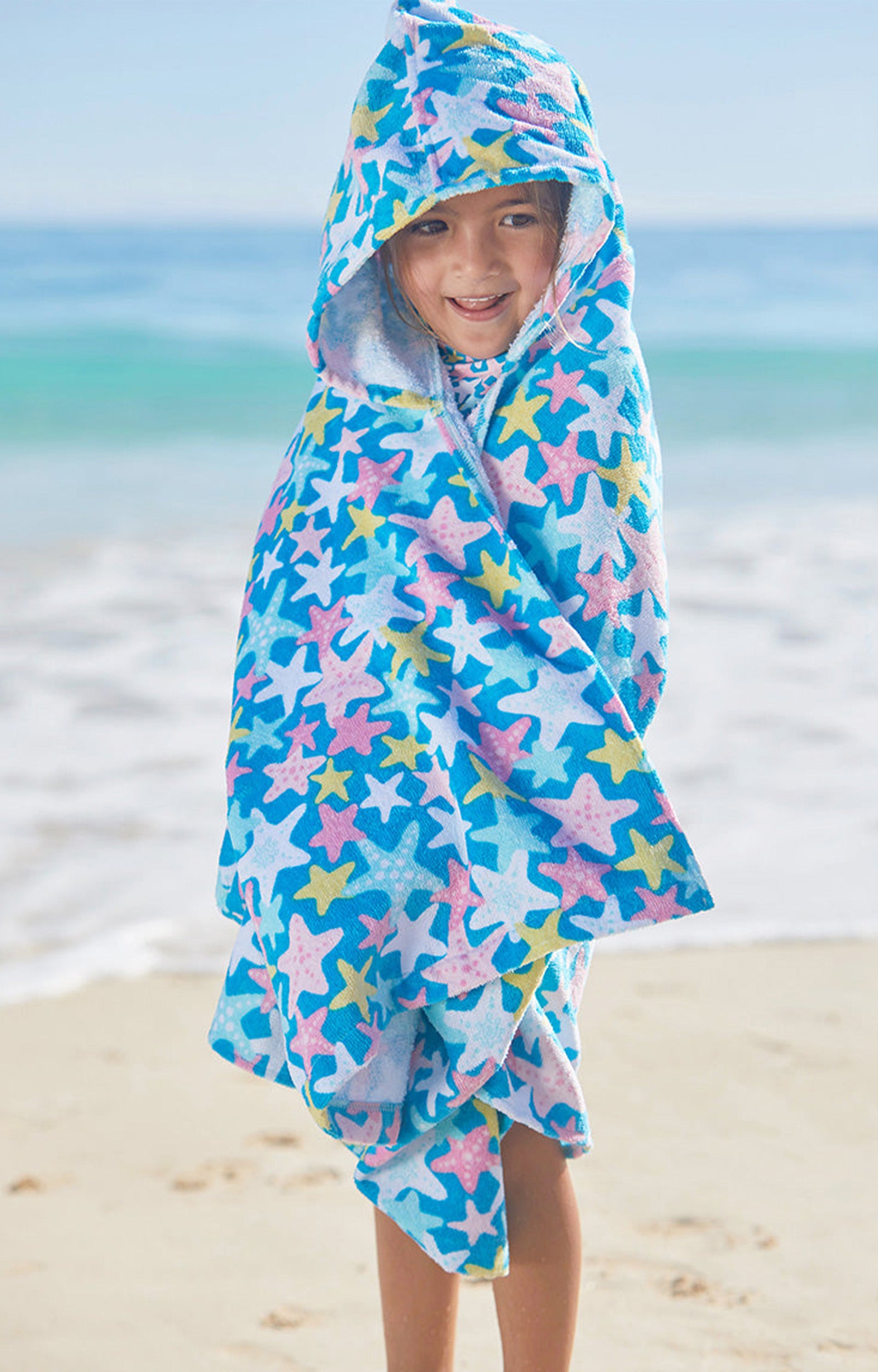 Kid in UV Skinz's kid's hooded beach towel in starfish party|starfish-party