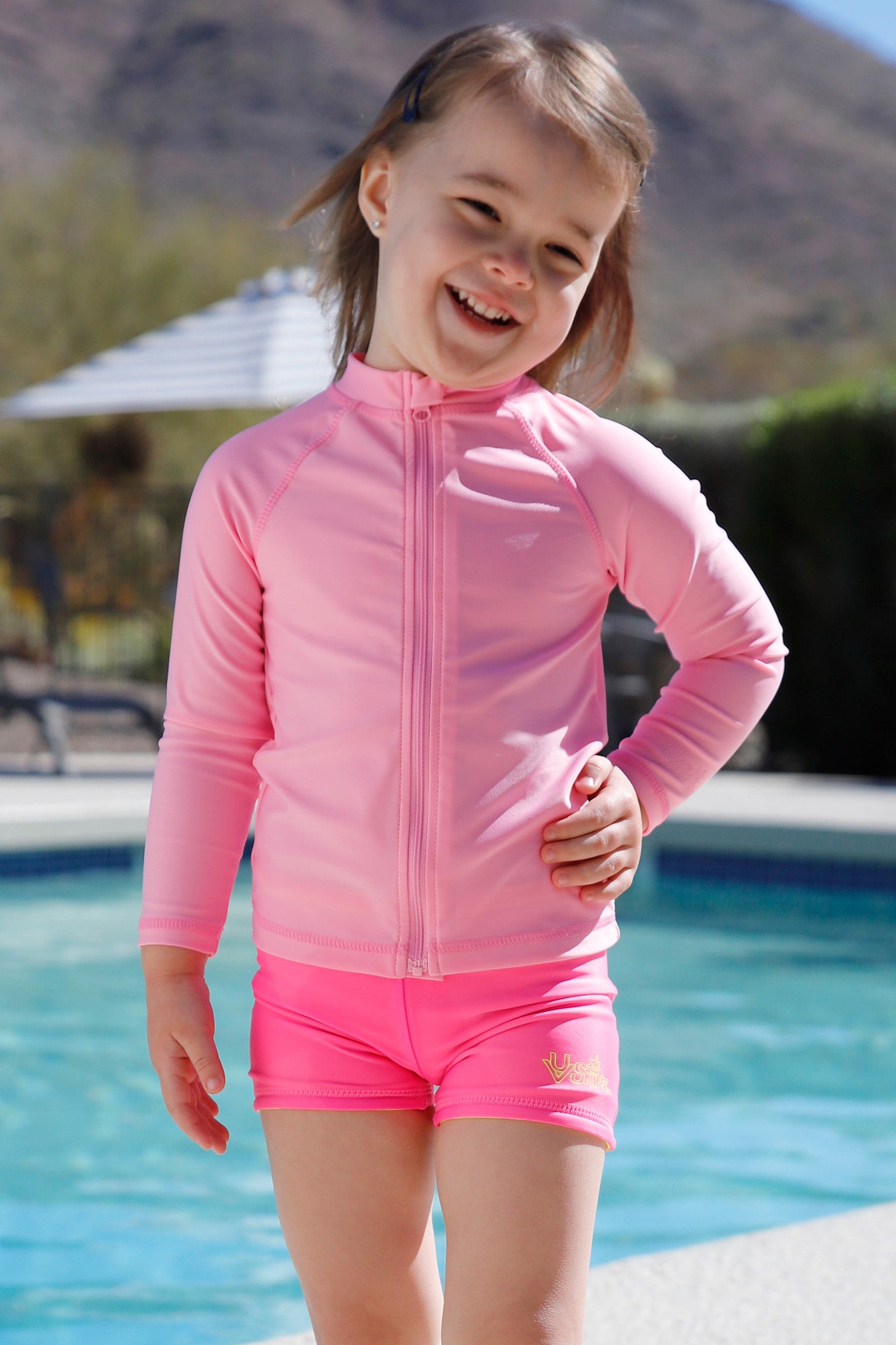 kid by pool in full zip rashguard|light-pink