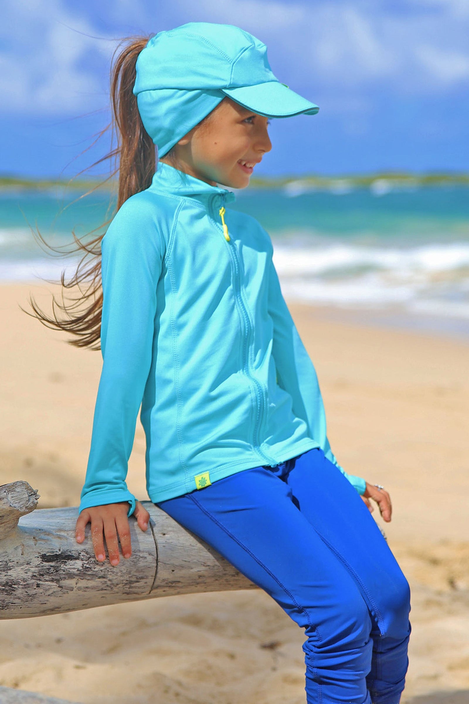 Little girl in UV Skinz's kid's active fleece hat in scuba blue|scuba-blue