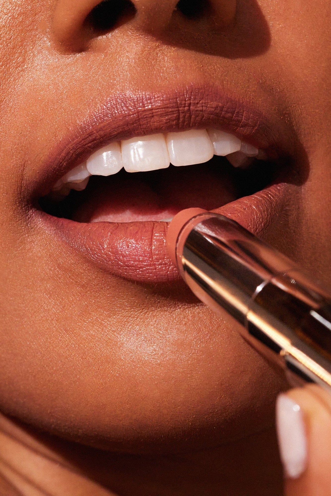 Woman putting on MDSolarSciences' lip balm in bare|bare