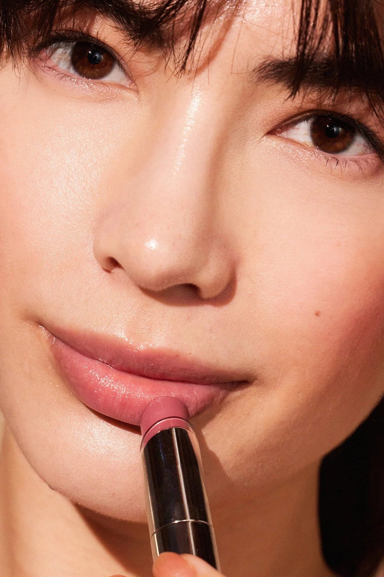 Woman wearing MDSolarSciences' lip balm in blush|blush