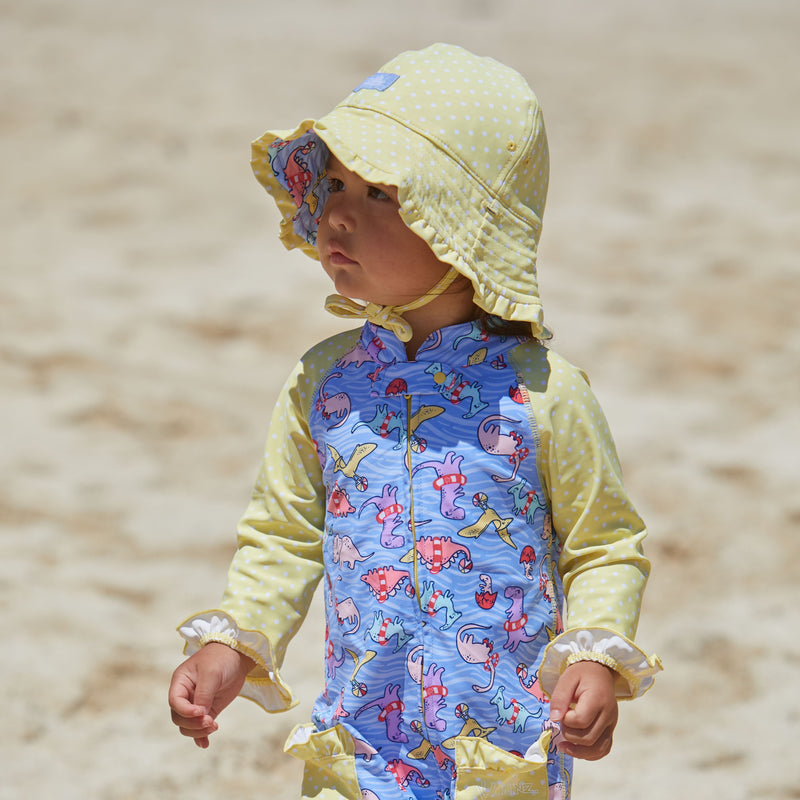 Little Girl in UV Skinz's Baby Girl's Reversible Sun Hat in Girly Dino Pool Party|girly-dino-pool-party