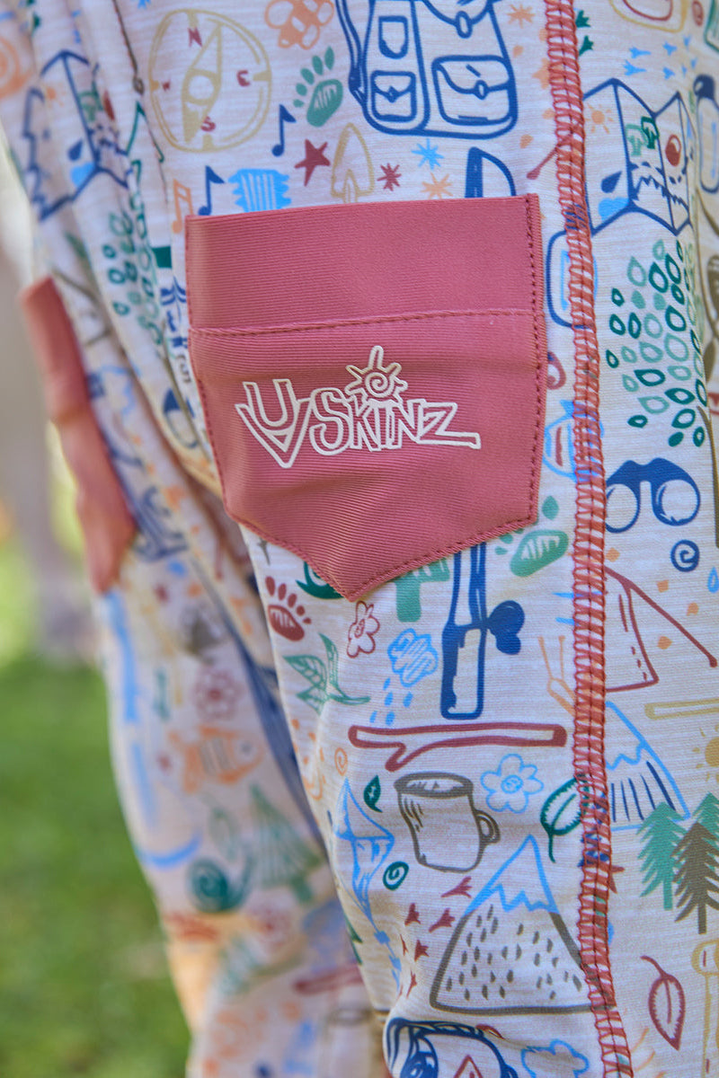 Close up of the pockets on the baby boy's long-sleeve swimsuit in campfire doodle|campfire-doodle