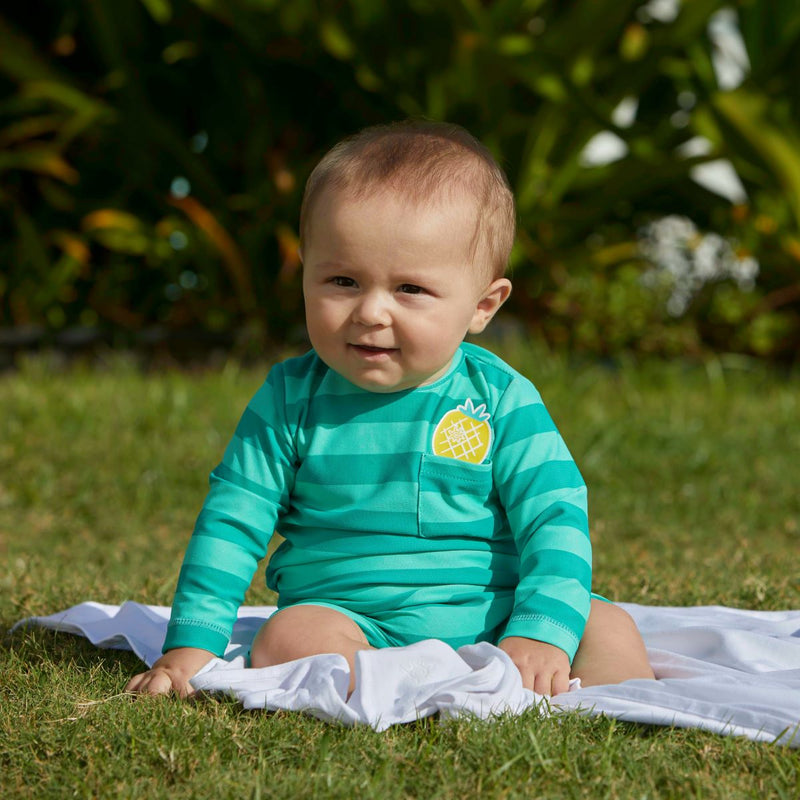 Little boy wearing UV Skinz's baby boy's onesie in pineapple rugby stripe|pineapple-rugby-stripe