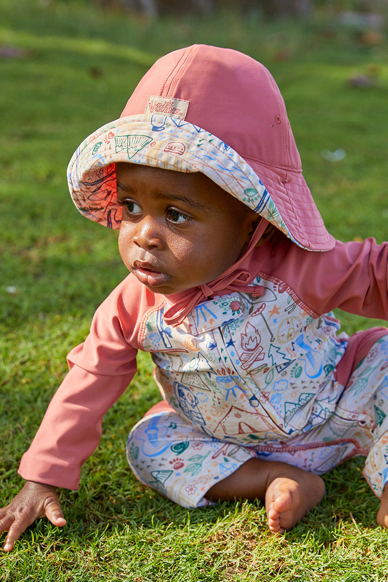 Baby boy in UV Skinz's boy's long-sleeve swimsuit and matching bucket hat in campfire doodle|campfire-doodle