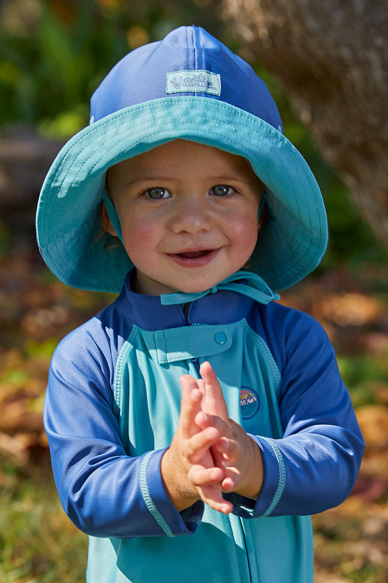 Baby boy in the baby boy's sun hat in washed navy river|washed-navy-river