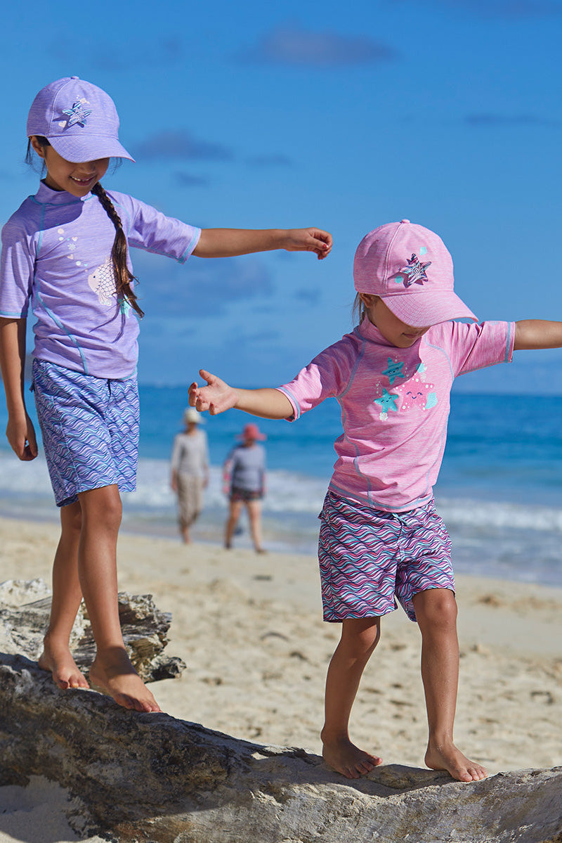 Little girls in UV Skinz's girl's short sleeve sport sun and swim shirt in sea star jaspe|sparkle-fish-jaspe