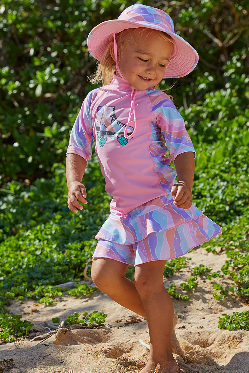 little girl in UV Skinz's girl's short sleeve sunny swim shirt in rollin along|rollin-along