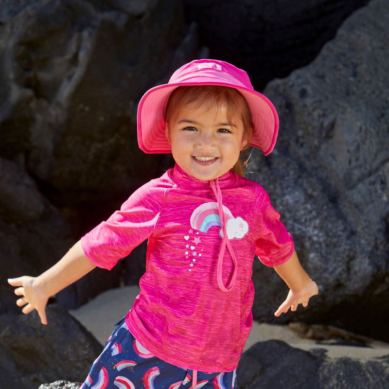 Little girl wearing UV Skinz's hot pink bubblegum swim hat|hot-pink-bubblegum