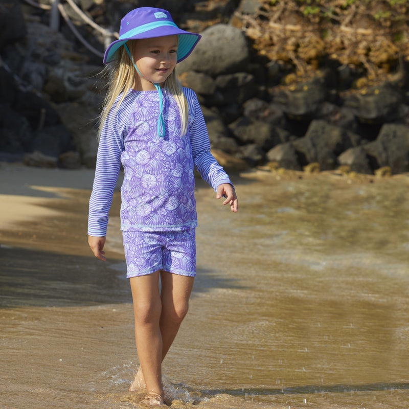 Little girl wearing UV Skinz's girls swim hat in purple scuba blue|purple-scuba-blue