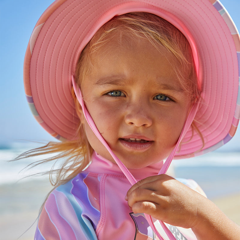 Baby girl in UV Skinz's girls swim hat in rollin along|rollin-along