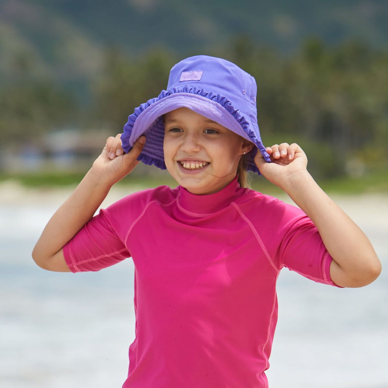 Girl wearing UV Skinz's girls bucket hat in purple misty purple|purple-misty-purple