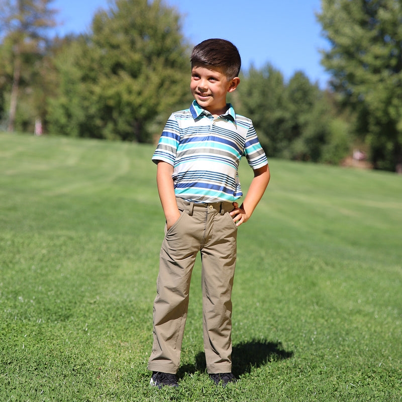 boy on the golf course in the boy's fairway pants in deep olive|deep-olive
