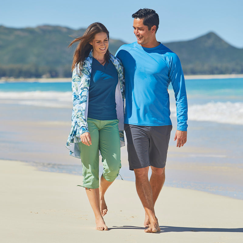 Woman Walking with Her Husband on the Beach in UV Skinz's Women's V-Neck Sun & Swim Shirt in MIdnight|midnight