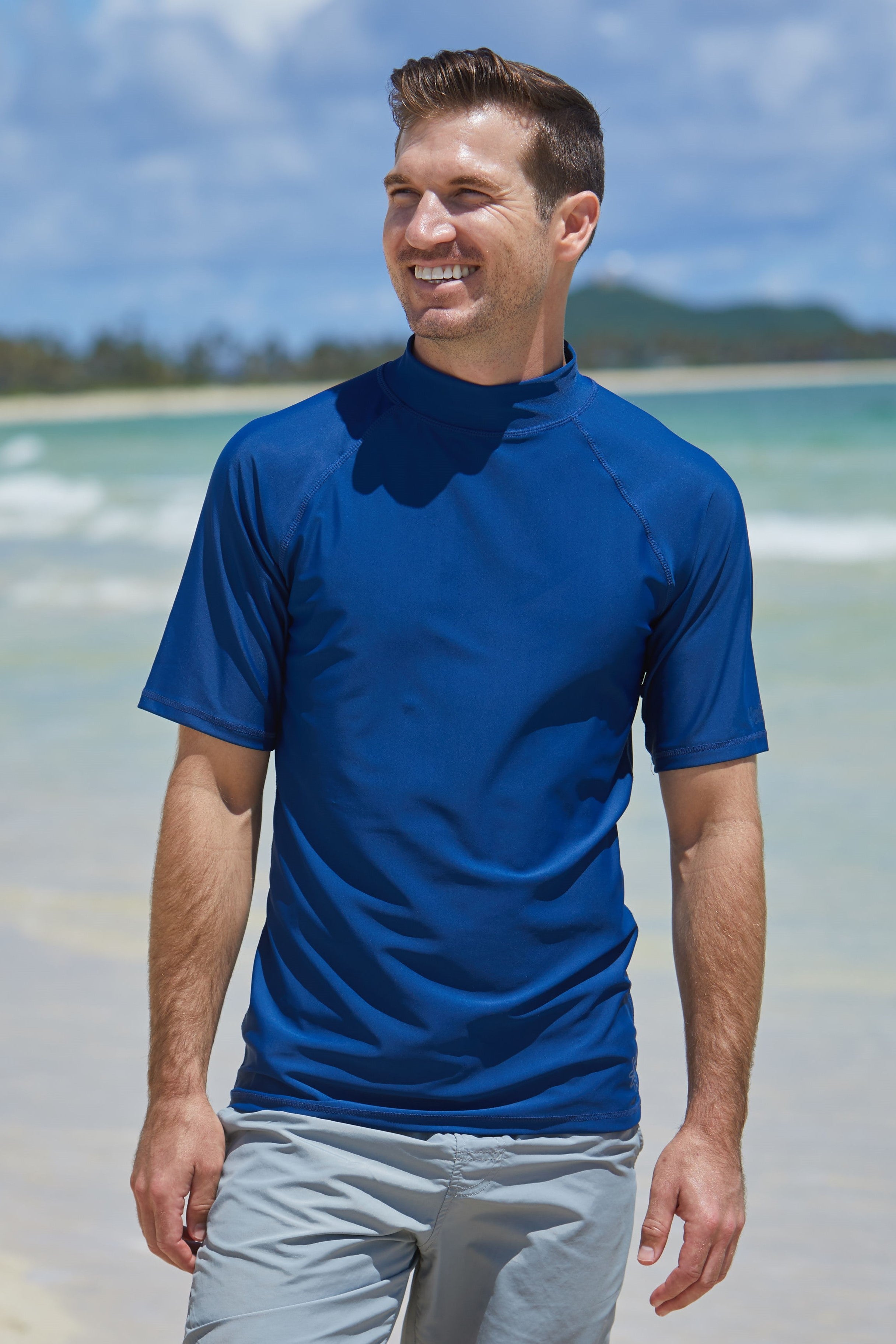 Man wearing UV Skinz's men's short sleeve swim shirt in dark navy|dark-navy