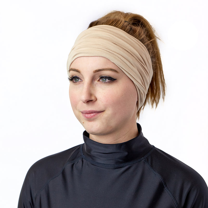 Woman Wearing UV Skinz's Bamboo UV Neck and Face Covering in Sand as a Headband|sand