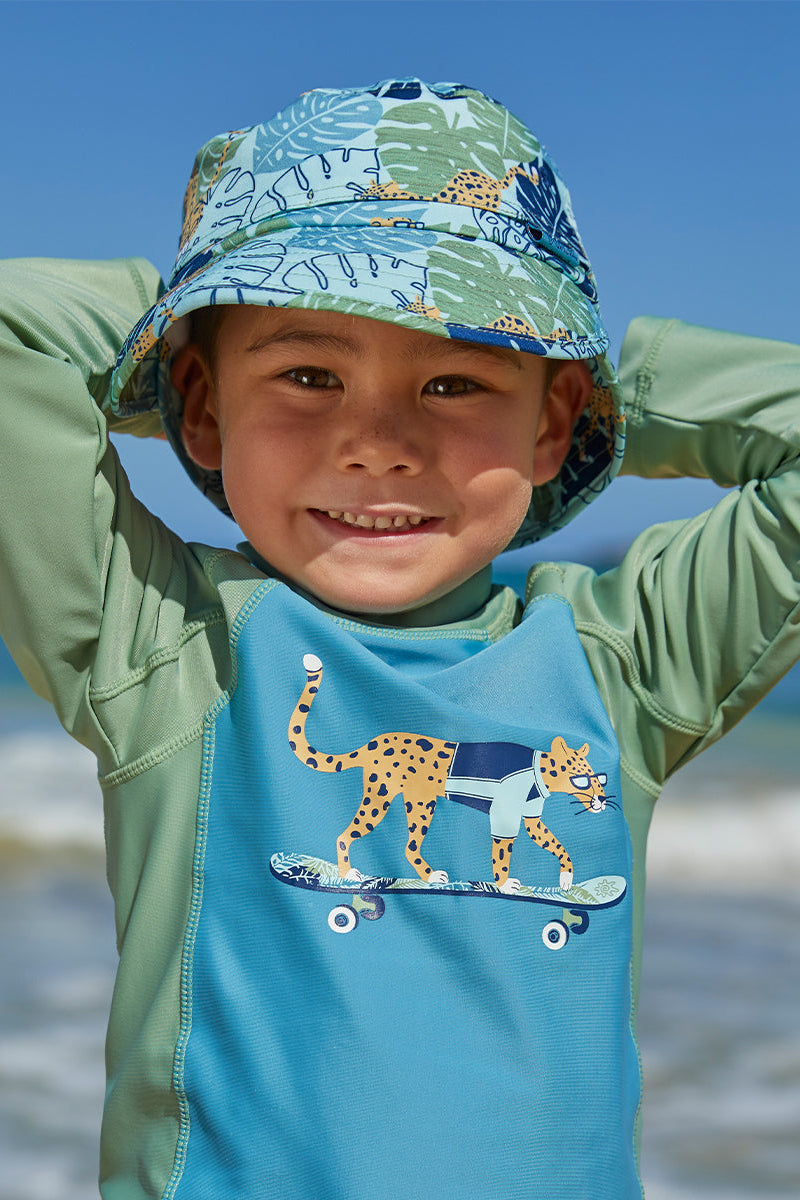Little boy in UV Skinz's kid's adjustable flap sun hat in cool cat|cool-cat