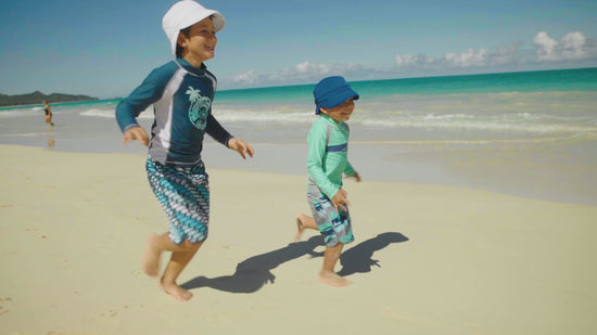 Little boys playing in UV Skinz's boy's long sleeve active swim shirts