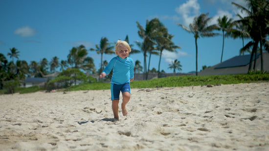 Little boy in UV Skinz's boy's swim shorts
